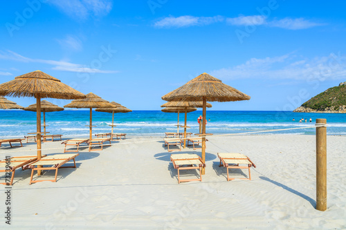 Villasimius beach with sunchairs and umbrellas, Sardinia island