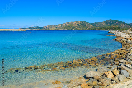 Rocks in azure sea water of Sardinia island at Campulongu beach