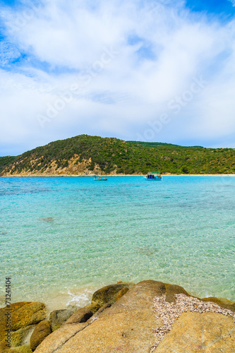 Fishing boat on turquoise sea water, Cala Pira, Sardinia island