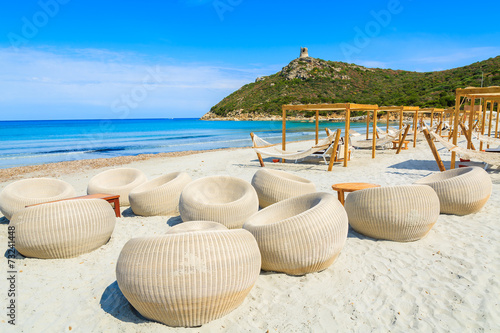 Chairs in a bar on white sand Porto Giunco beach, Sardinia