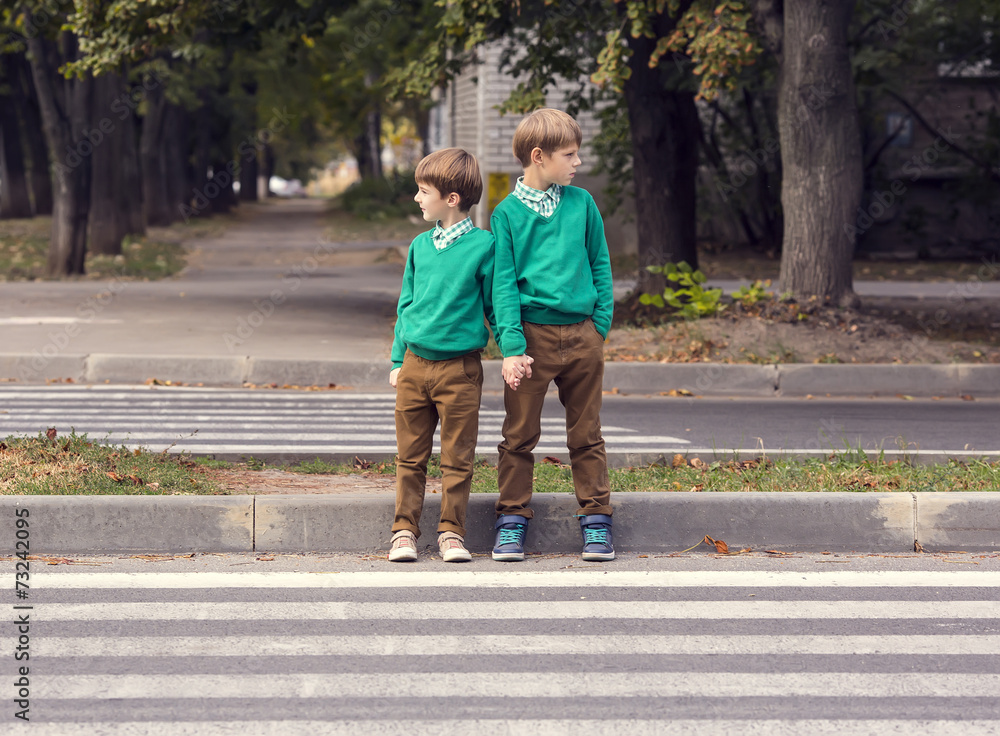 Fototapeta premium Portrait of a boy on a background of green nature