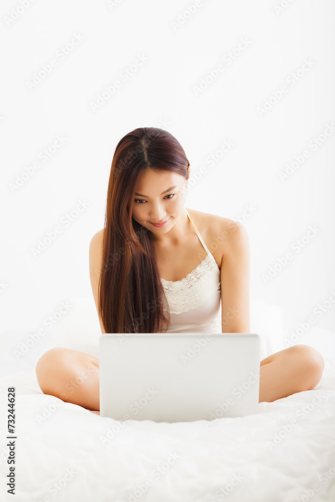 beautiful young asian woman using laptop in bed beautiful young asian woman using laptop in bed