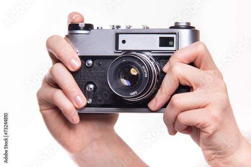 Classic 35mm photo camera in hand photo