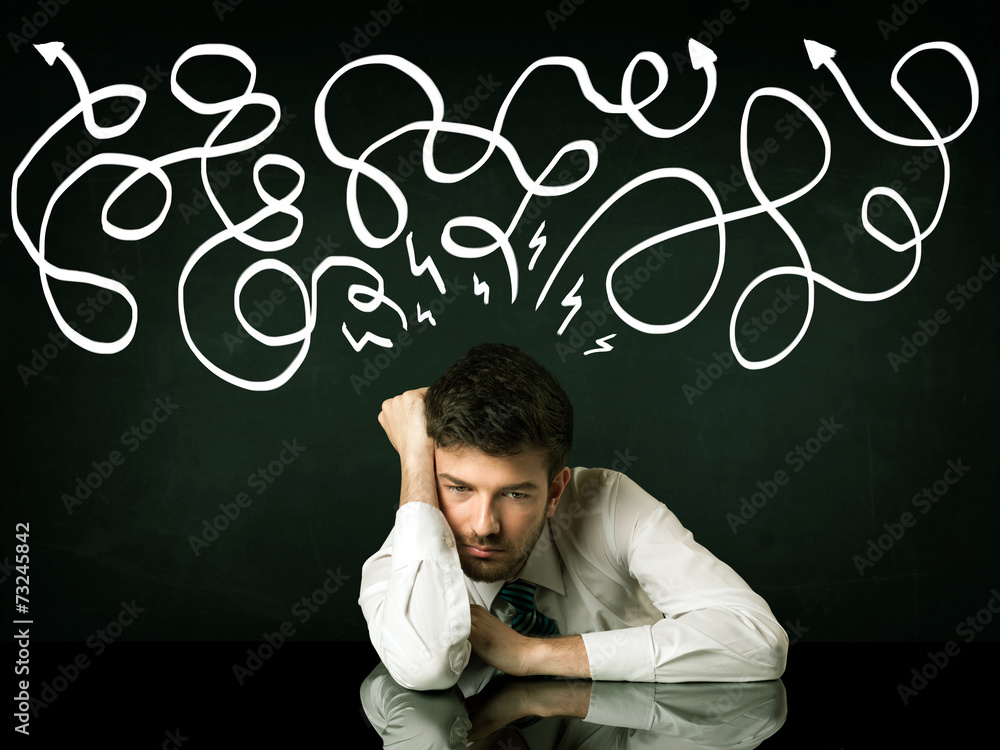 Depressed businessman sitting under drawn direction lines