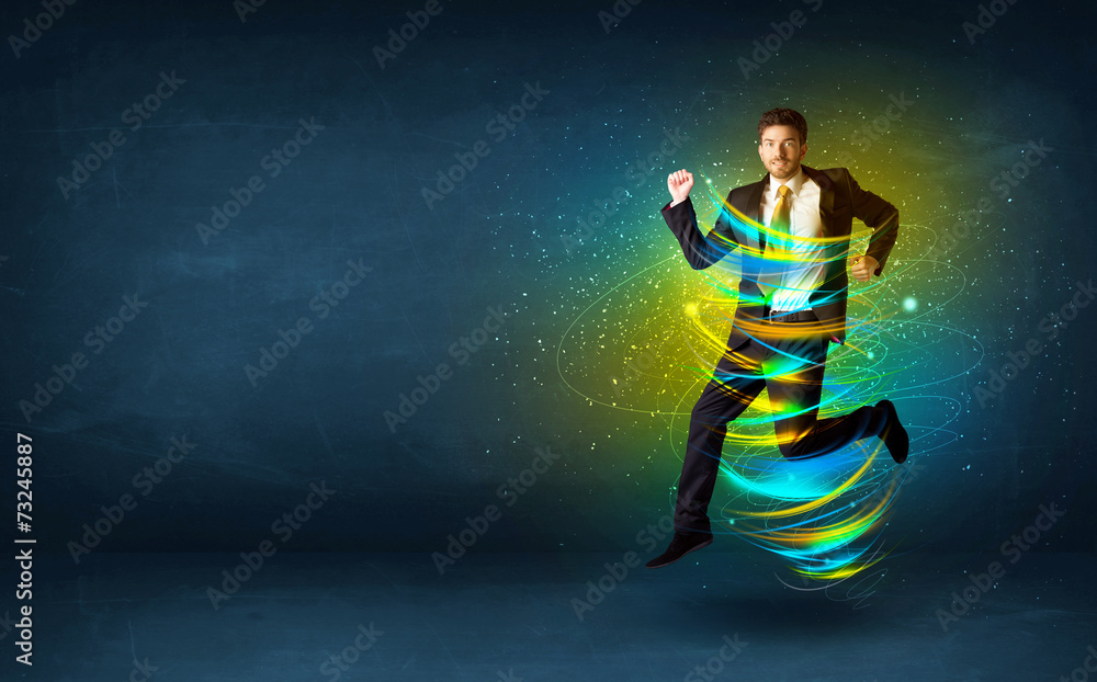 Excited business man jumping with energy colourful lines