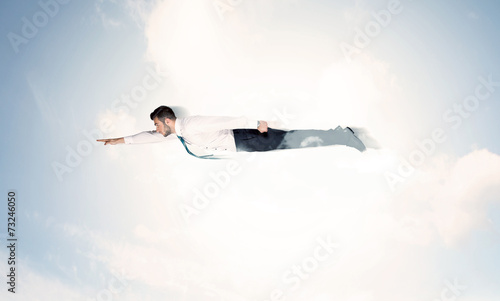 Business man flying like a superhero in clouds on the sky