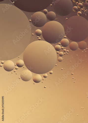 Bubbles floating on water with texture against a colored backgro