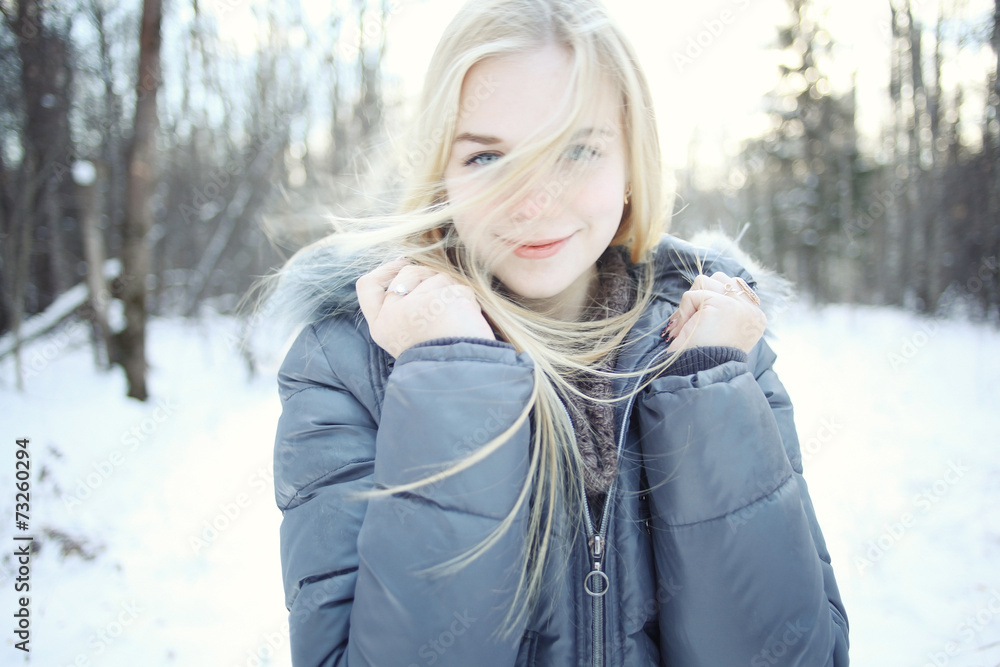 portrait of a young blonde girl in winter forest in the park portrait of a young blonde girl in winter forest in the park