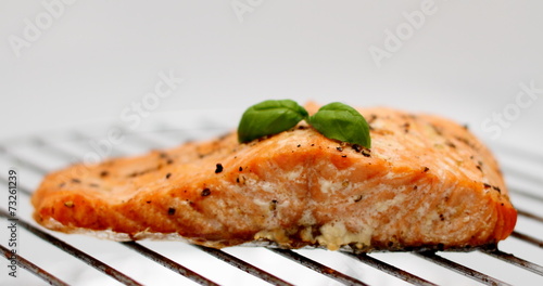 Grilled salmon fillet on grill, soft focus