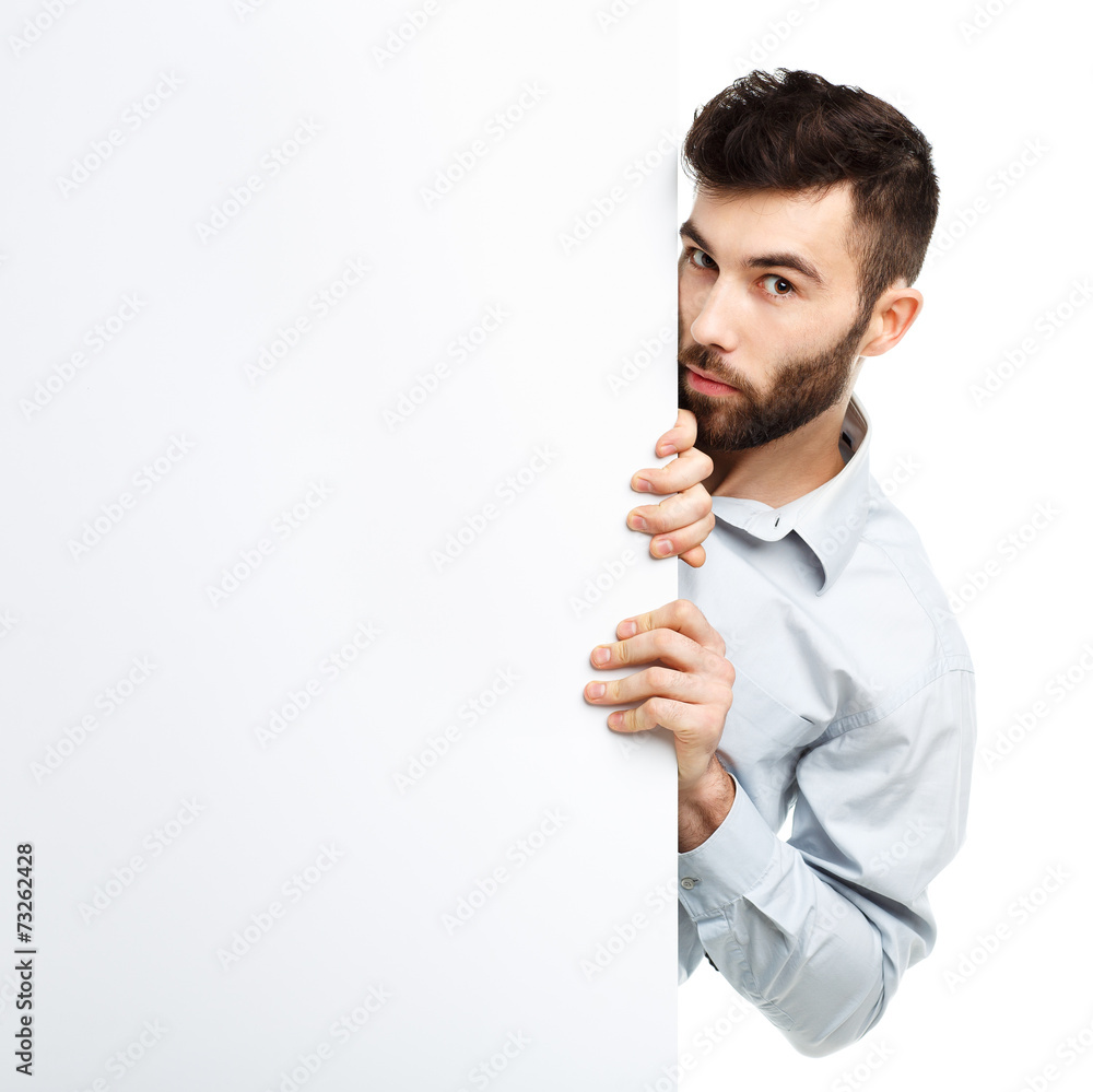 A young bearded man showing blank signboard, isolated over white A young bearded man showing blank signboard, isolated over white
