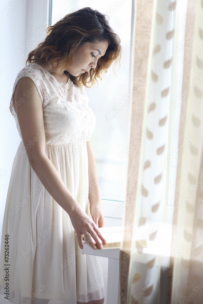 girl standing at the window girl standing at the window