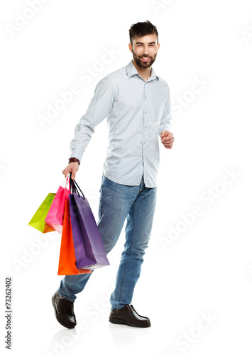 Handsome smiling man holding shopping bags