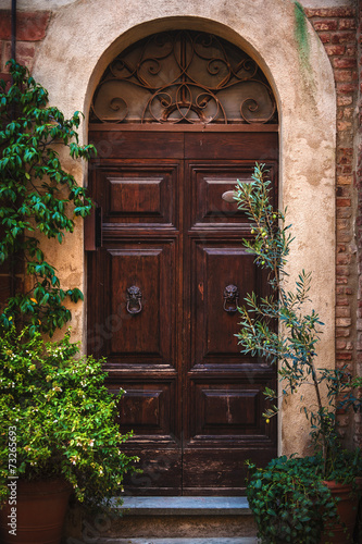 Door in the alley of the old Tuscan town, Italy