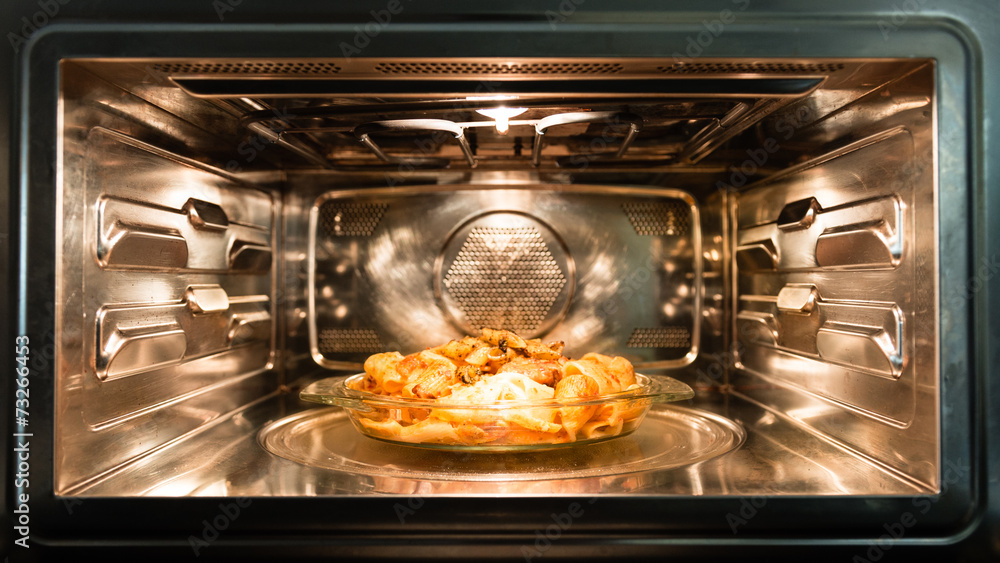 Italian Christmas dinner preparation: baked pasta in the oven Italian Christmas dinner preparation: baked pasta in the oven