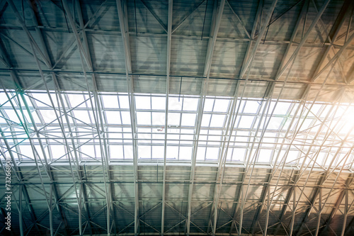 metal roof at urban terminal with sun shining through windows