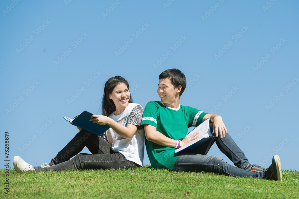 Couple of Asian students outdoors looking very happy