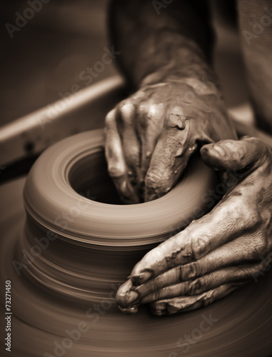 Fototapeta Hands working on pottery wheel