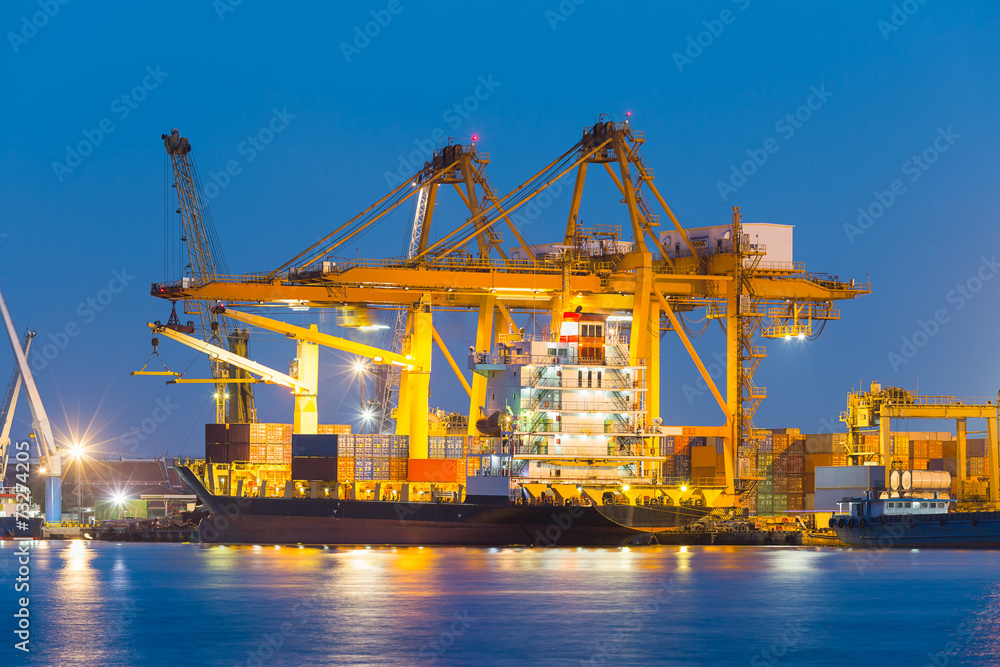 Gantry crane loading and unloading cargo container  from cargo ship at port to show global international logistics and transportation by cargo ship and cargo container, Logistic import export concept.