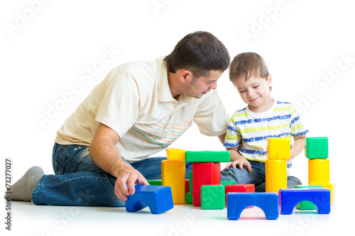 kid and his dad play toys together