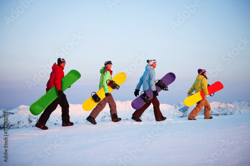 Group of snowboarders on top of the mountain