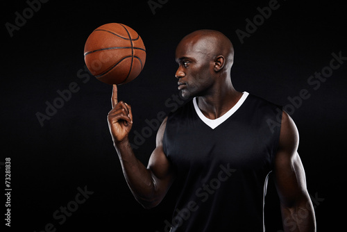 Young african athlete balancing basketball on his finger © Jacob Lund