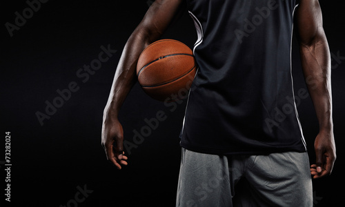 Afro american basketball player holding a ball