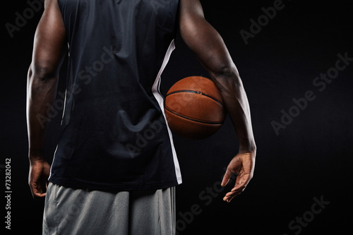 African basketball player with a ball in his arm