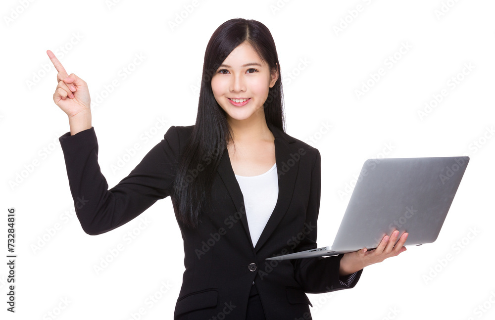 Businesswoman use of laptop and finger point up Businesswoman use of laptop and finger point up