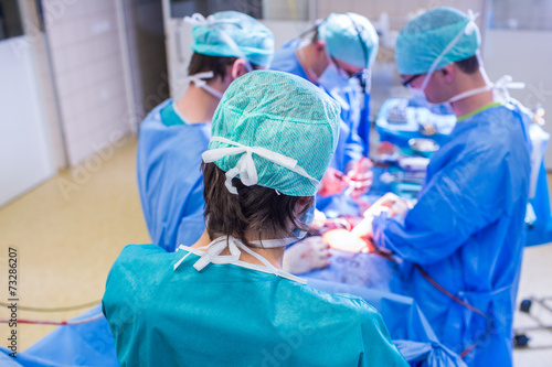 Team of surgeons performing an operation on a patient