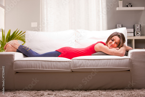 pensive woman on a couch at home
