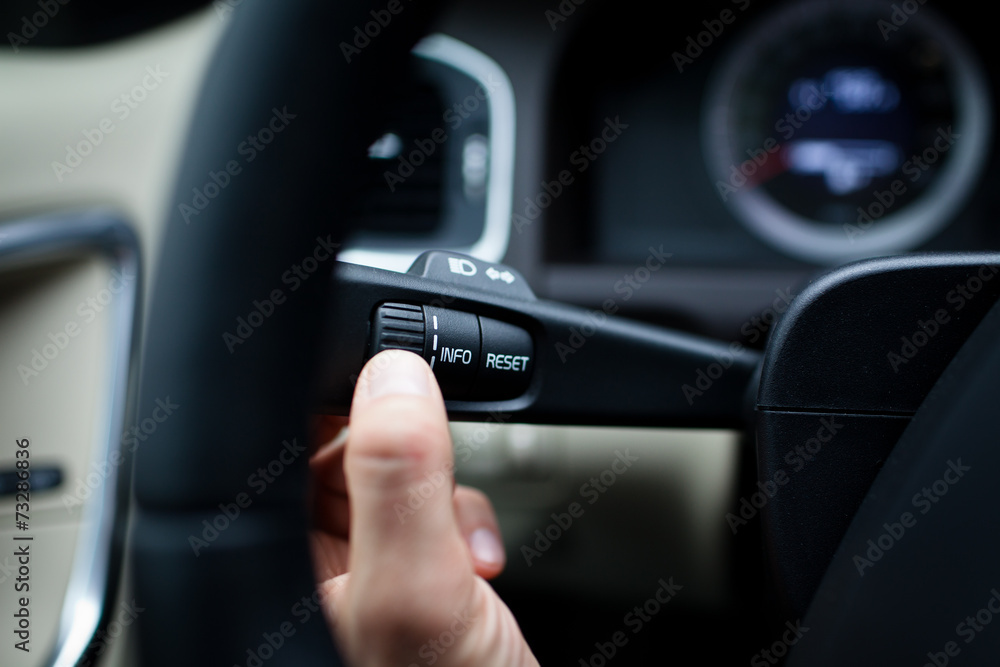 Modern car interior - driver pressing a button Modern car interior - driver pressing a button