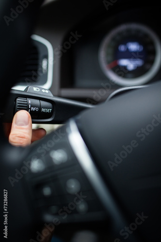 Modern car interior - driver pressing a button © lightpoet