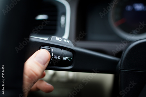 Modern car interior - driver pressing a button