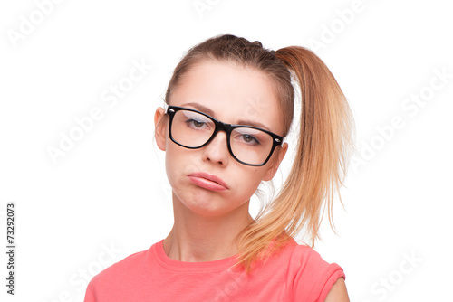 Disappointed teen girl in glasses