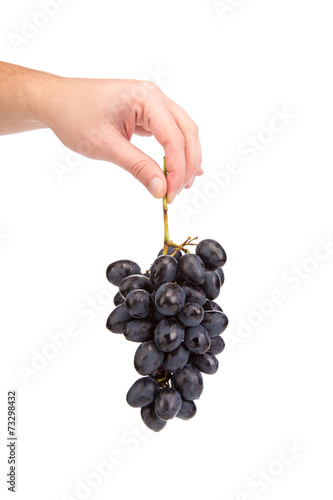 Hand holding red grape