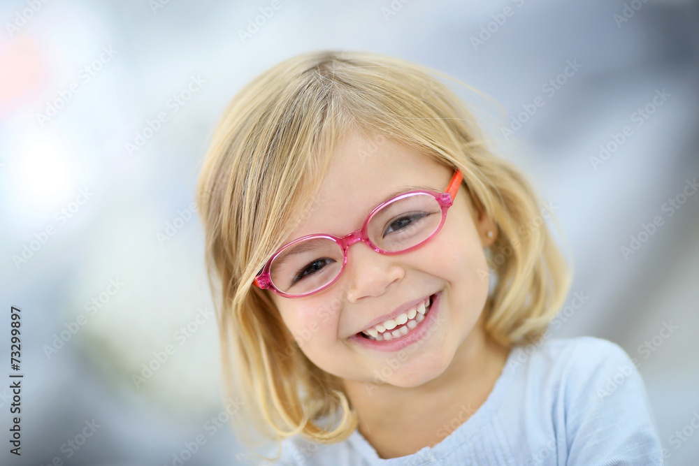 Cute blond little girl with pink eyeglasses Cute blond little girl with pink eyeglasses