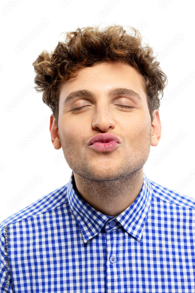 Fototapeta premium Portrait of a handsome young man kissing camera