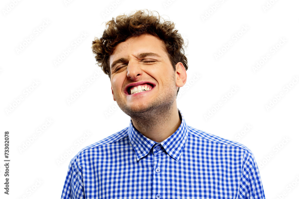 Man showing his teeth over white background Man showing his teeth over white background
