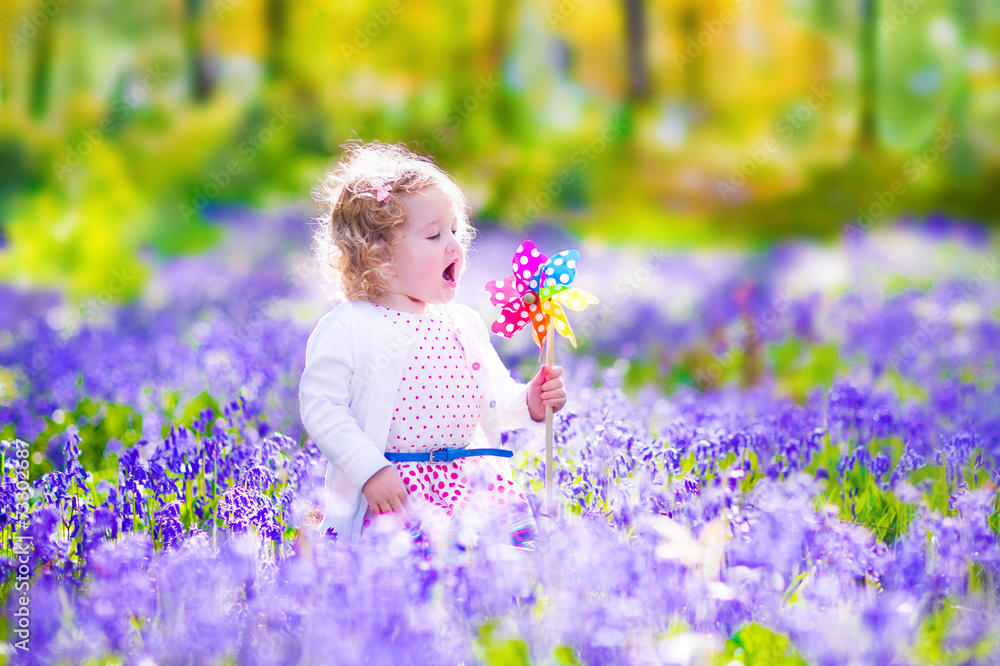 Little girl in a spring forest Stock Photo | Adobe Stock