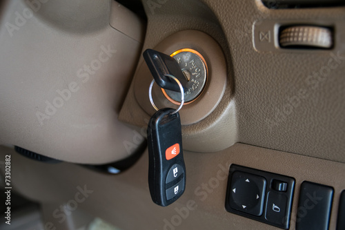 Fotografie car key in ignition start lock