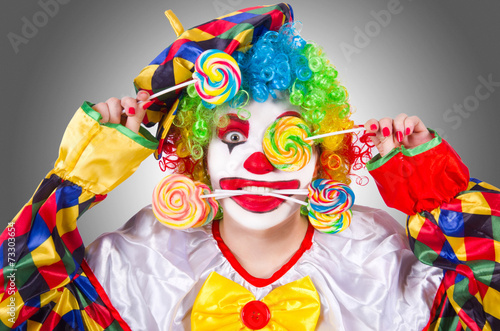 Clown with lollipops isolated on white