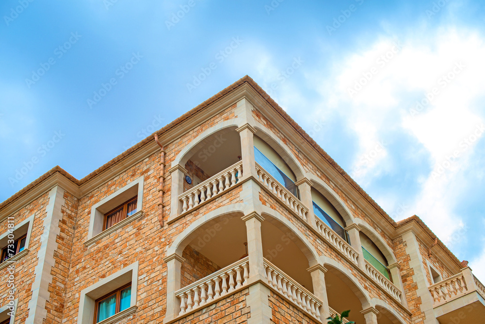 Portrait of tropical apartment building with balconies.