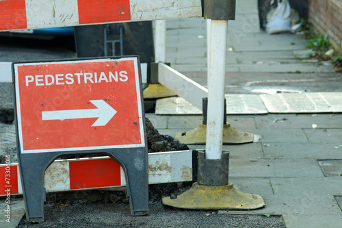 Pedestrians this way sign