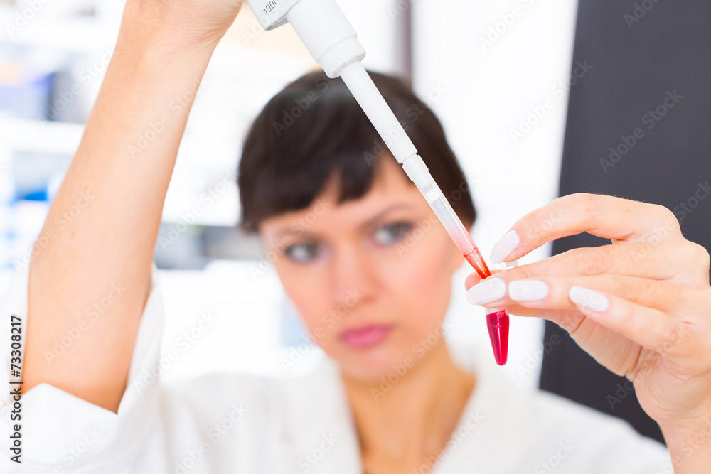 woman in a laboratory with microtube test tube in hand and PCR woman in a laboratory with microtube test tube in hand and PCR
