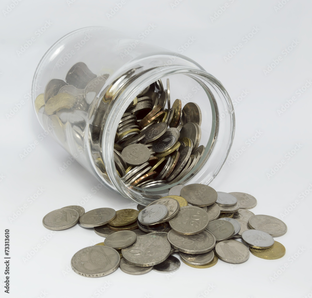 Coins inside glass jar with white background Coins inside glass jar with white background