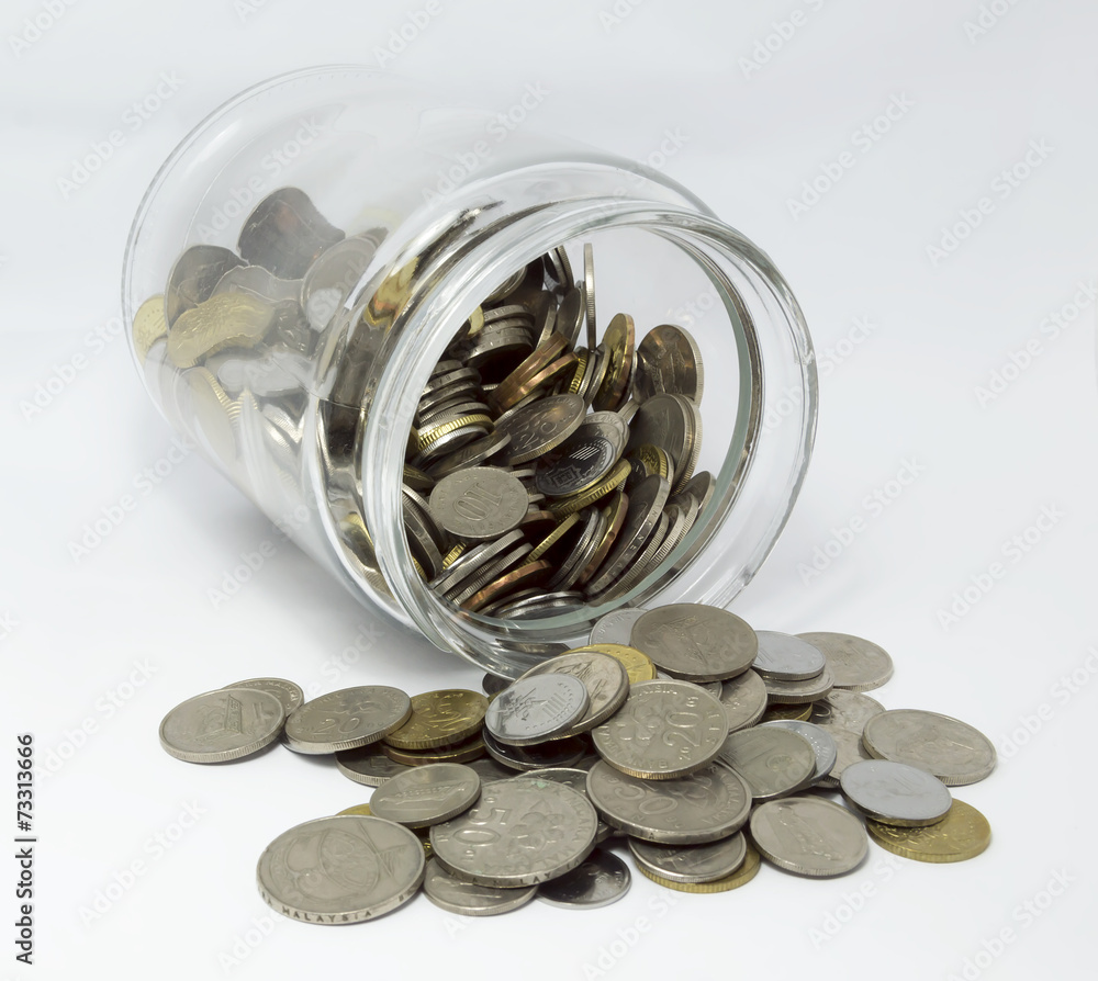Coins inside glass jar with white background Coins inside glass jar with white background