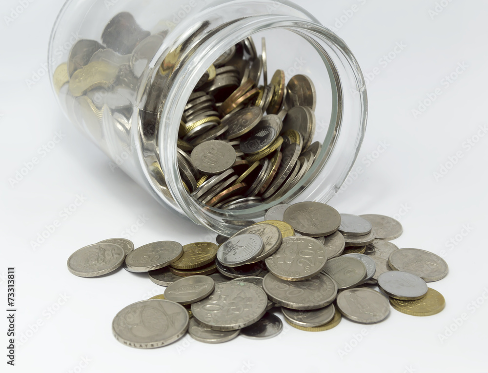 Coins inside glass jar with white background Coins inside glass jar with white background