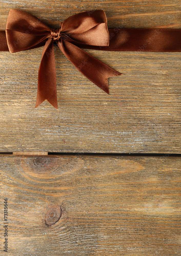 Old wooden background with beautiful bow Old wooden background with beautiful bow
