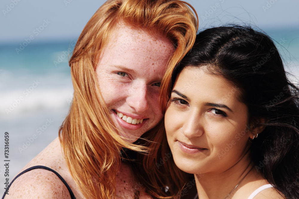 two smiling young teenage girlfriends on the beach two smiling young teenage girlfriends on the beach