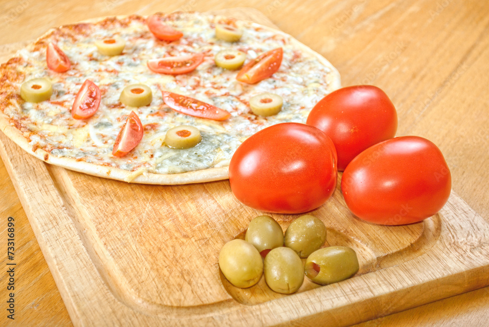 Fresh pizza on wooden table Fresh pizza on wooden table